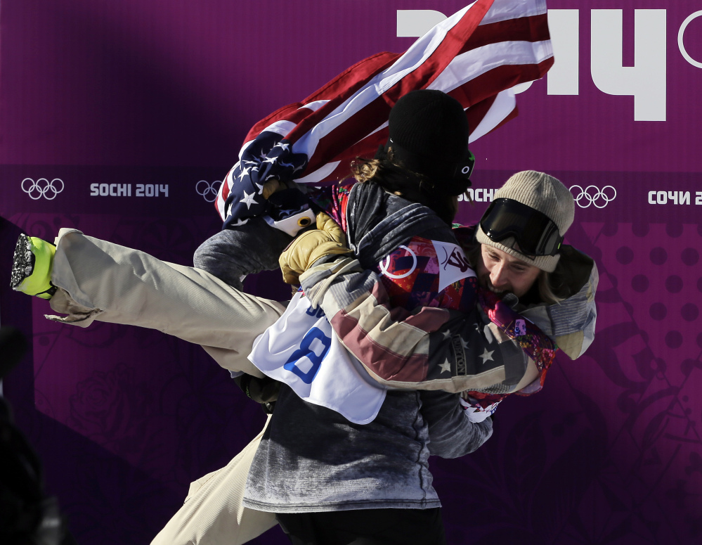 United States’ Sage Kotsenburg, right, is carried by Norway’s Staale Sandbech after Kotsenburg won the men’s snowboard slopestyle final at the Rosa Khutor Extreme Park, at the 2014 Winter Olympics, Saturday.
