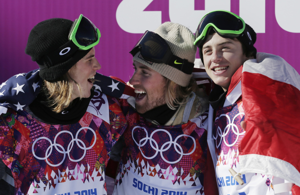United States’ Sage Kotsenburg, center, celebrates with Norway’s Staale Sandbech, left, and Canada’s Mark McMorris after Kotsenburg won the men’s snowboard slopestyle final at the Rosa Khutor Extreme Park. Sandbech took the silver medal and McMorris took bronze.