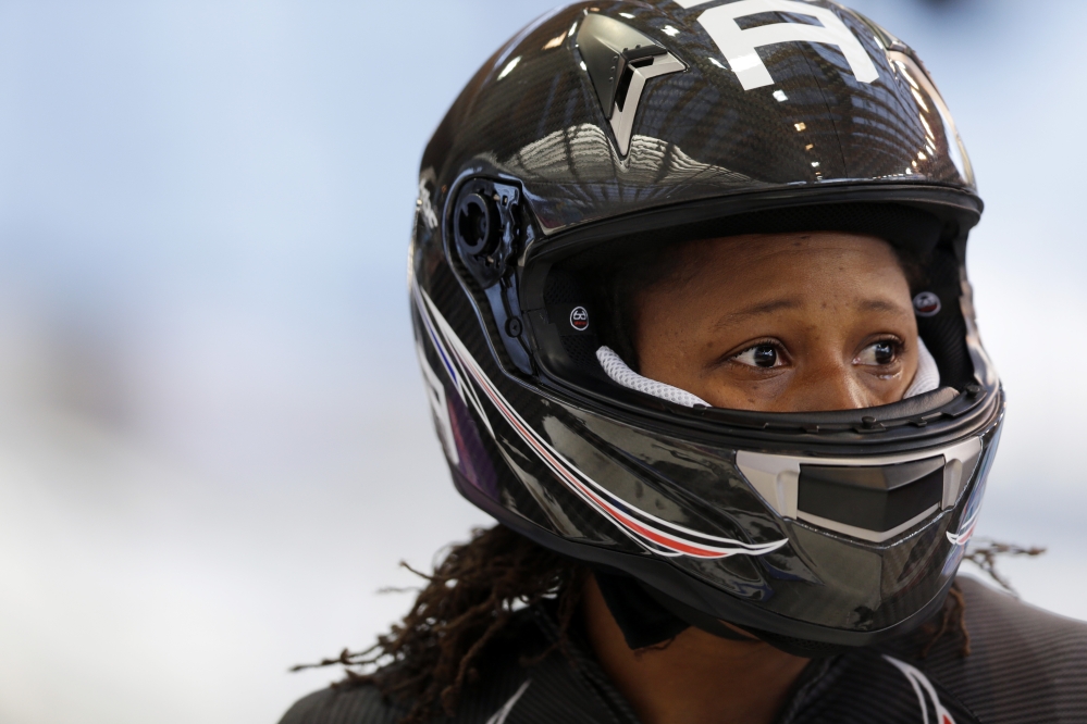 Lauryn Williams with the United States team, gets out of her sled after a training run for the two-man bobsled at the 2014 Winter Olympics,