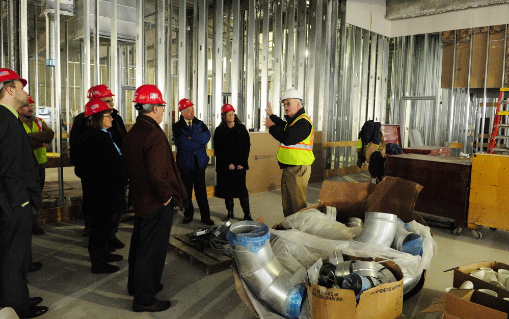 Courthouse progress: Phil Johnston, a project manager, wearing a white helmet, leads a tour for the Legislature’s Judiciary Committee on Thursday at the new court building in Augusta.