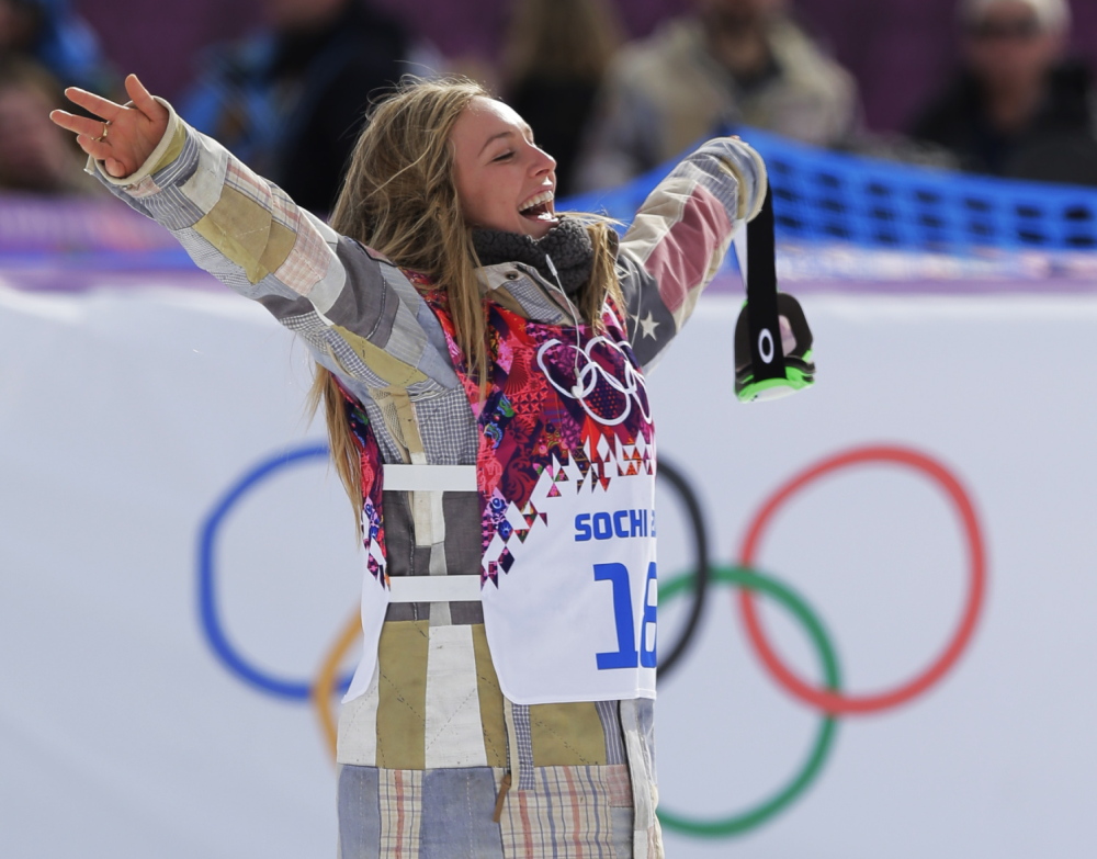 Jamie Anderson of the United States celebrates on the way to the flower ceremony after winning the women’s snowboard slopestyle final at the 2014 Winter Olympics on Sunday in Krasnaya Polyana, Russia.