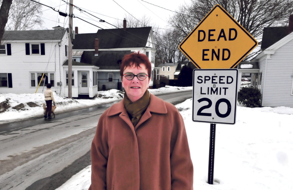 ROOTS: Author Rhea Cote Robbins stands along Water Street in the South End section of Waterville. Her book “‘down the Plains’” is about growing up in a home nearby.