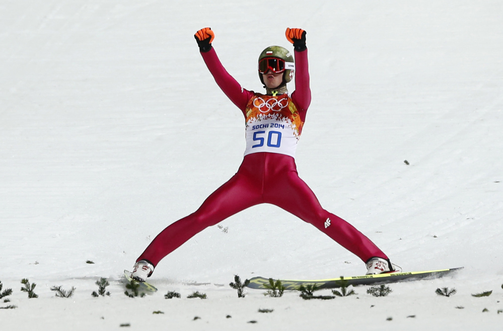 Poland’s Kamil Stoch celebrates winning the gold after his second attempt during the men’s normal hill ski jumping final Sunday at the 2014 Winter Olympics at Krasnaya Polyana, Russia.