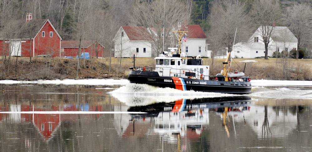 A Coast Guard ice cutter cruises up the Kennebec River. Bath Iron Works is in the running for the design of a new cutter.
