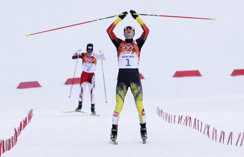 Germany’s Eric Frenzel celebrates winning the gold after the cross-country portion of the Nordic combined at the 2014 Winter Olympics