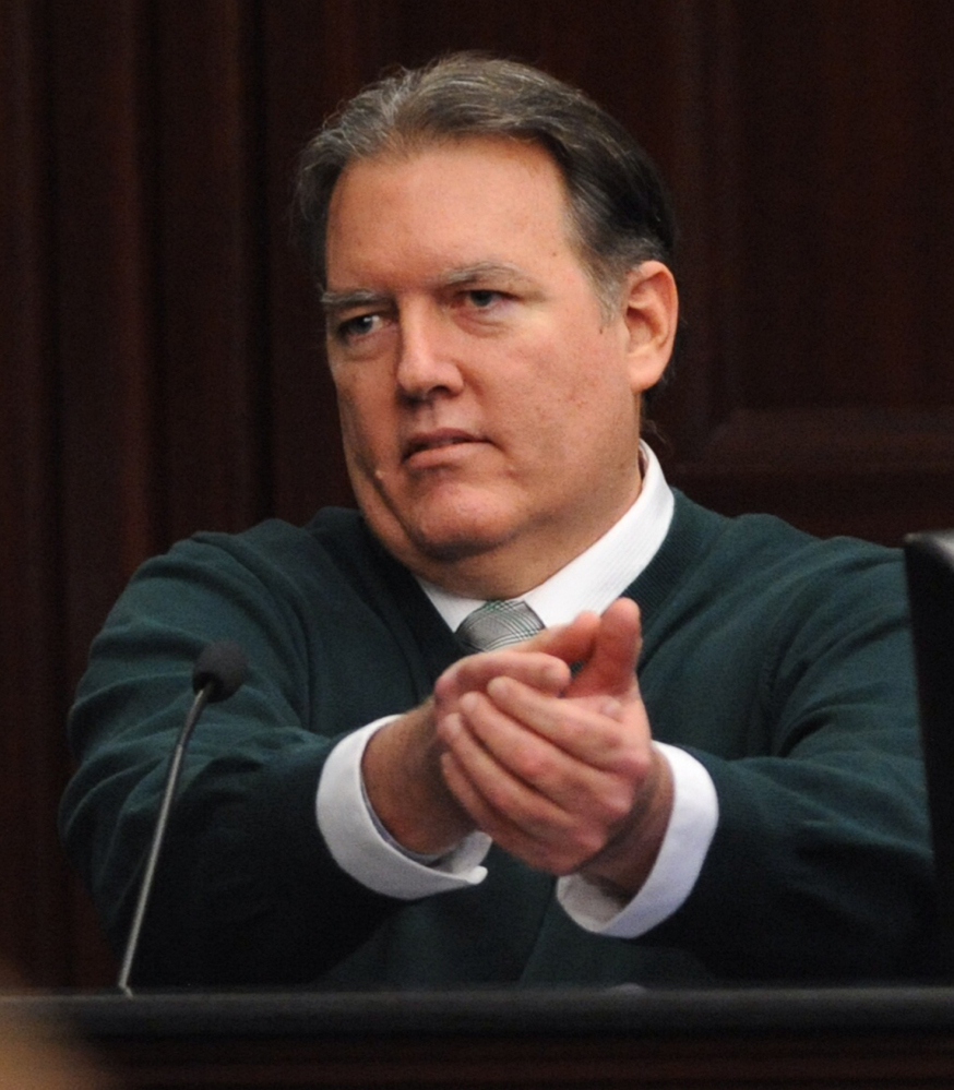 Michael Dunn, gestures on the stand in his own defense during his trial in Jacksonville, Fla., Tuesday.