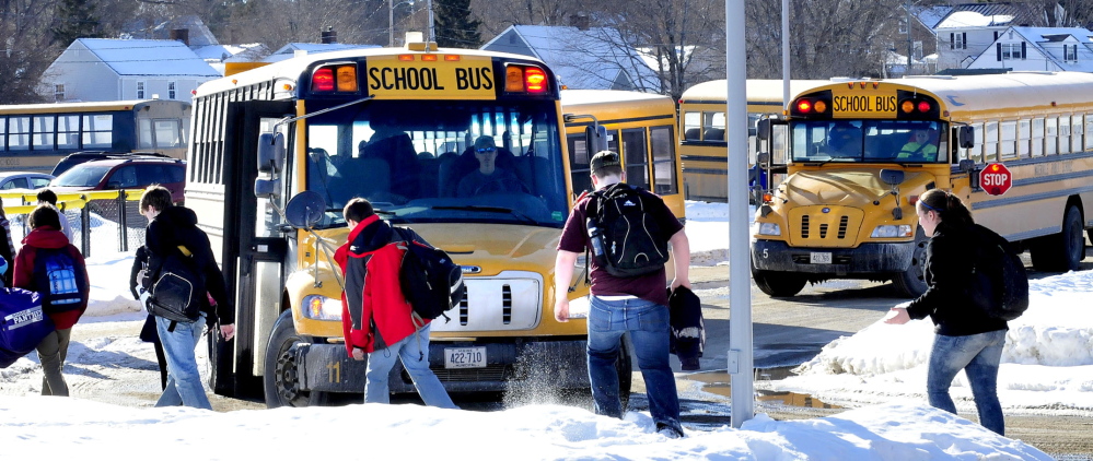 SNOW DAYS: Students board school buses Wednesday at Waterville Senior High School. They may get a break from school this Friday because a snowstorm, predicted to start Thursday afternoon, but that decision will be based on detailed forecasts sought by the superintendent.