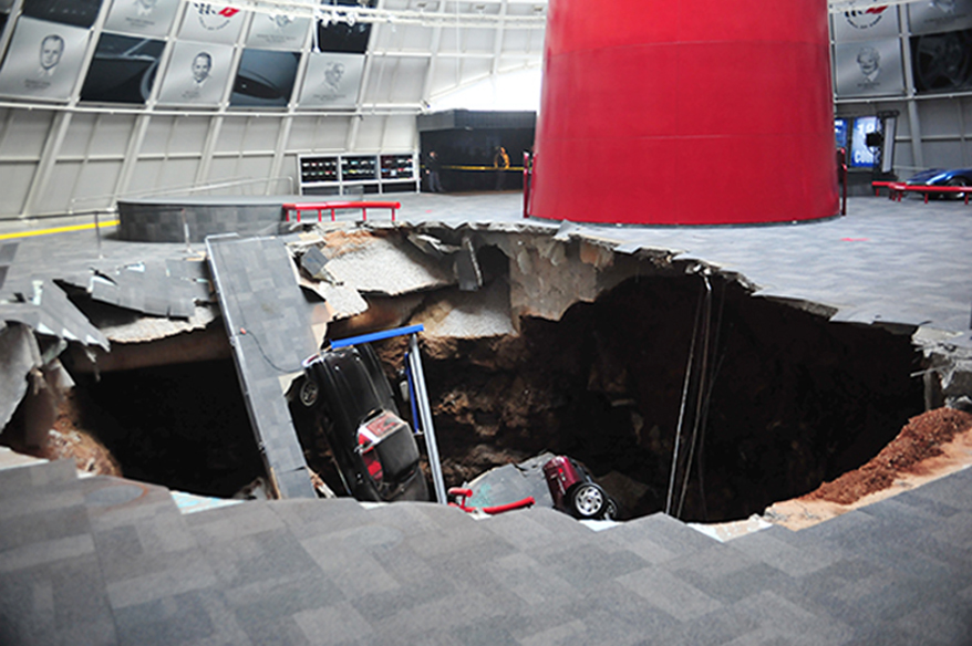 In this image provided by the National Corvette Museum shows several cars that collapsed into a sinkhole Wednesday, in Bowling Green, Ky. The museum said a total of eight cars were damaged when a sinkhole opened up early Wednesday morning inside the museum.