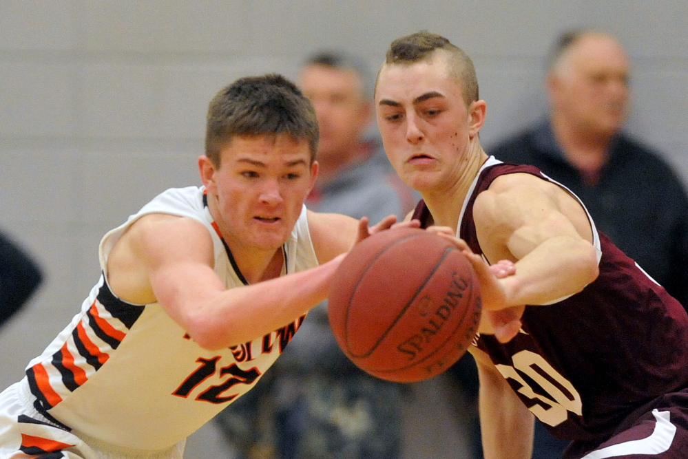 Staff photo by Michael G. Seamans HIGH SCHOOL BASKETBALL: Winslow High School's Connor Wildes, 12, steals a pass intended for Foxcroft Academy's Hunter Smith, 30, in the third quarter in Winslow on Wednesday.