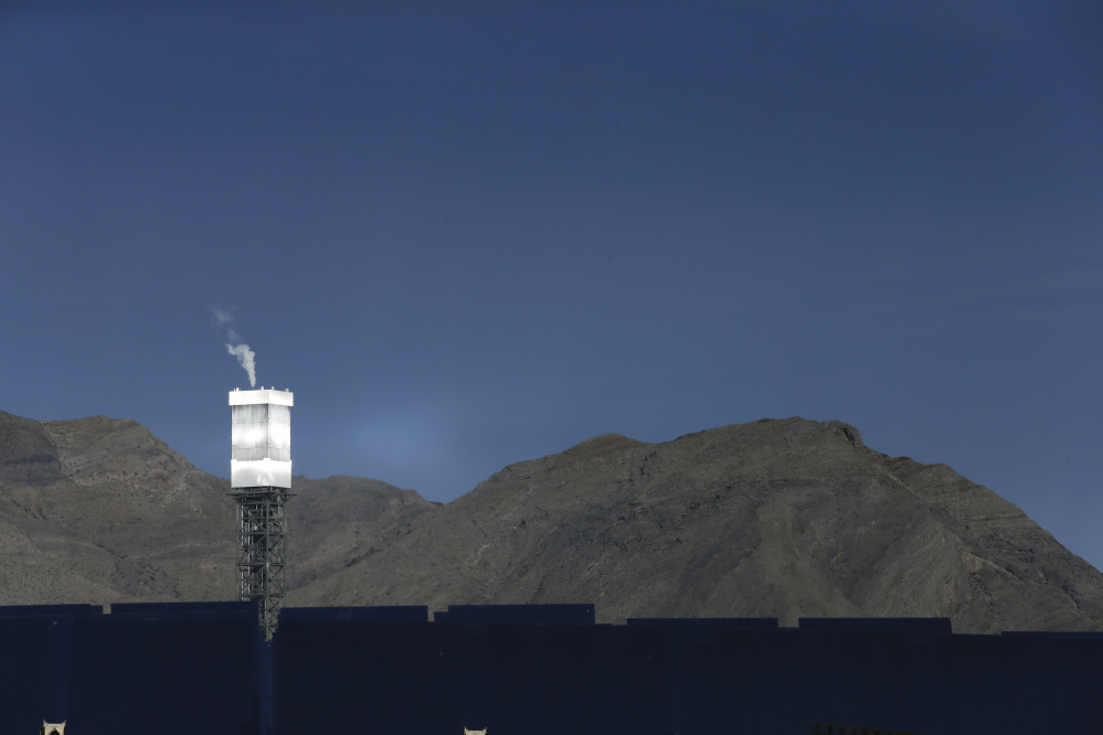 A boilers sits on 459-foot towers vents steam recently in Primm, Nev. The Ivanpah Solar Electric Generating System, sprawling across roughly 5 square miles of federal land near the California-Nevada border, opened formally Thursday after years of regulatory and legal tangles.