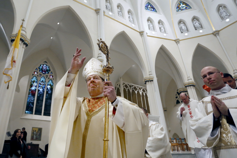 The Most Rev. Robert P. Deeley blesses the congregation during the closing recessional at the Cathedral of the Immaculate Conception in Portland on Friday. Deeley will celebrate Mass at 10 a.m. Sunday at the cathedral.