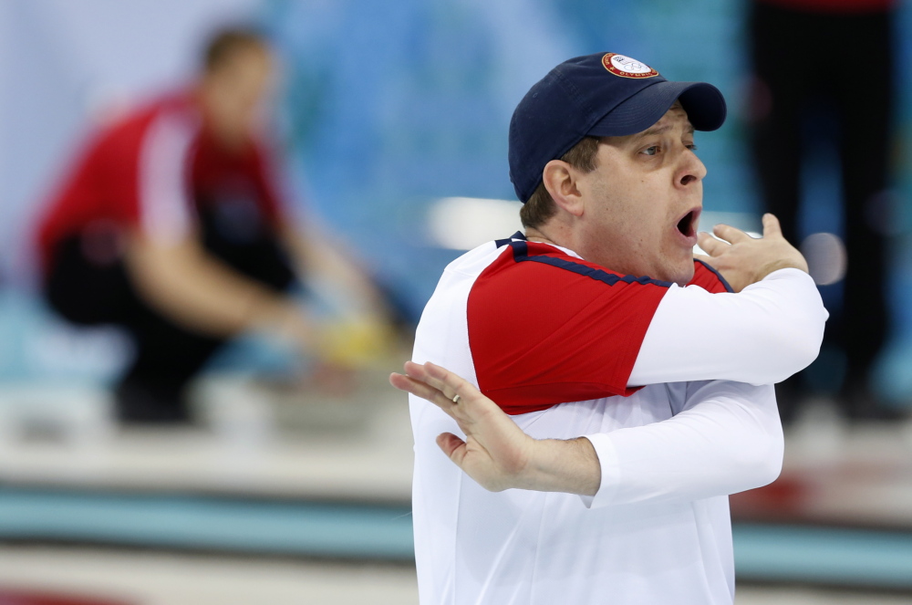John Shuster, skip of the United States curling team, swings his arms wildly as he yells to his team to sweep harder on the final throw in a round robin loss to Russia at the 2014 Winter Olympics on Friday in Sochi, Russia.