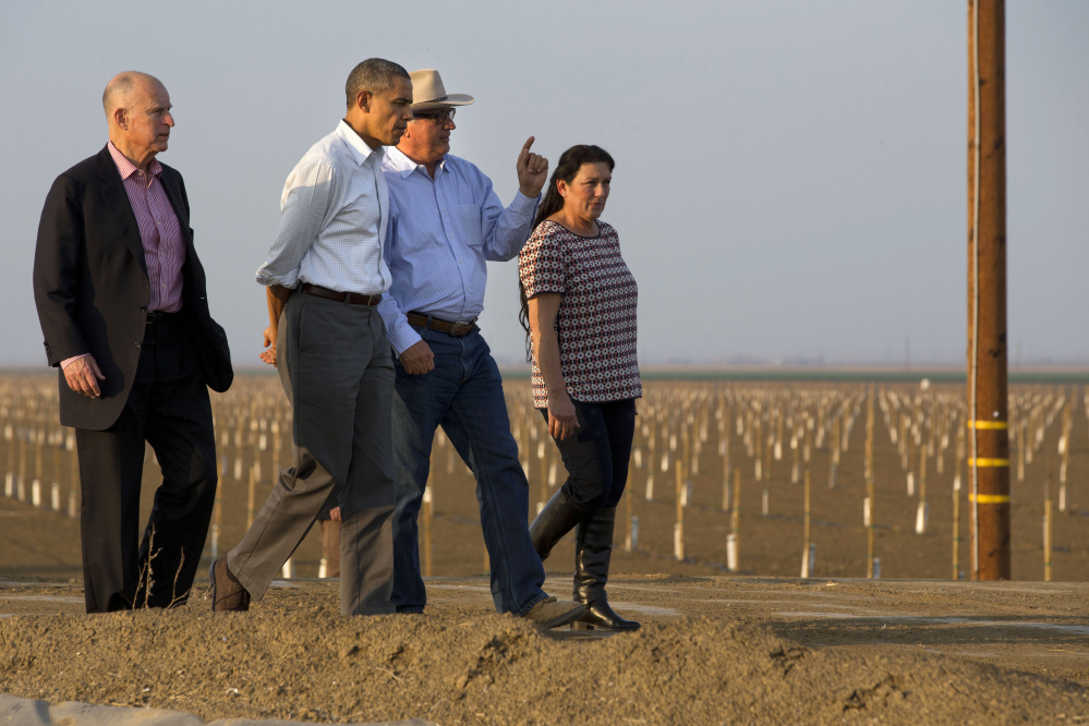 President Barack Obama tours a local farm with California Gov. Jerry Brown, left, and Joe Del Bosque, and Maria Gloria Del Bosque, of Empresas Del Bosque, Inc., in Los Banos, Calif., Friday, regarding the drought.