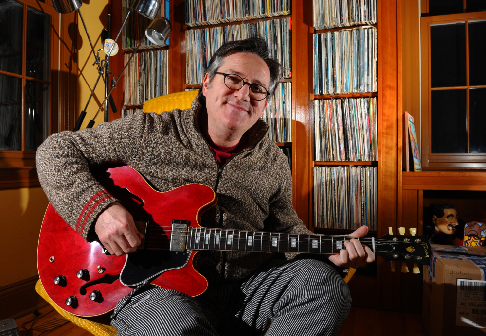 David Schneider poses with his new custom Gibson guitar at his home in Fairfield, Conn. It was given to him by Gibson after hearing of his plight of a Gibson guitar that was broken during baggage handling at Delta Airlines.