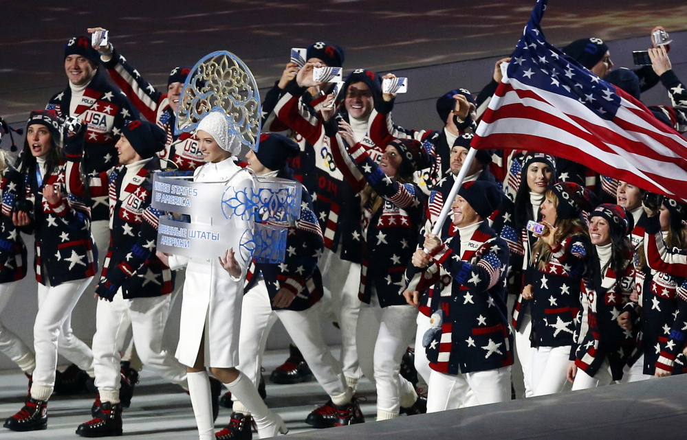 Members of the United States Olympic team – many of them holding up mobile phones to record the moment – enter Fisht Stadium in Sochi, Russia, for the opening ceremony of the 2014 Winter Olympics on Feb. 7, 2014. Picking up new followers on Twitter, Facebook and other social media platforms is the smart play for Olympians at the Sochi Games. Athletes who share their experiences from their privileged backstage access at the games could come home from Russia with far stronger hands to woo and squeeze more money from sponsors.
