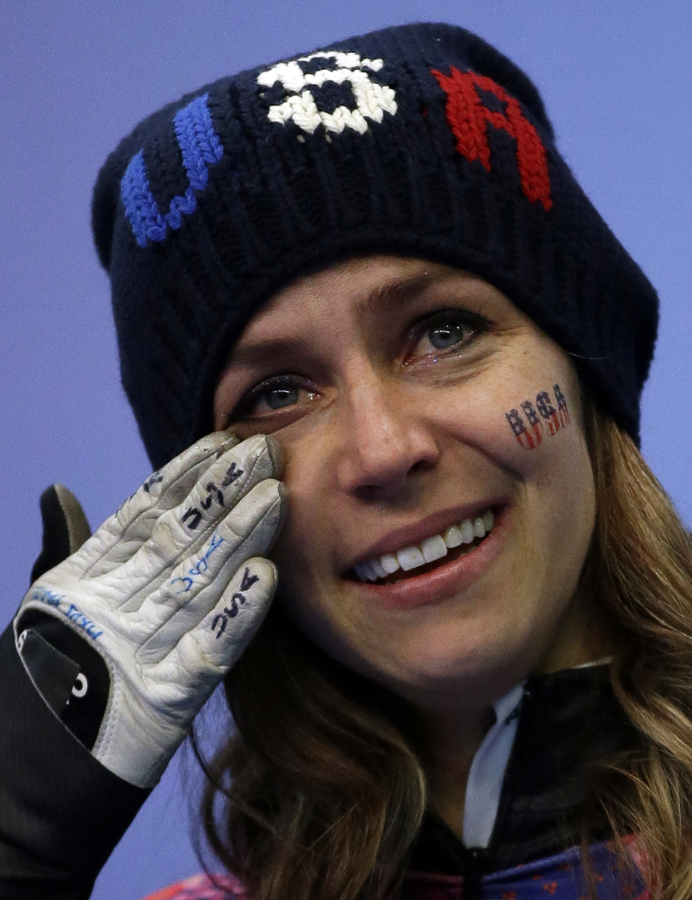 Noelle Pikus-Pace of the United States cries during the flower ceremony after winning the silver medal during the women’s skeleton competition at the 2014 Winter Olympics.