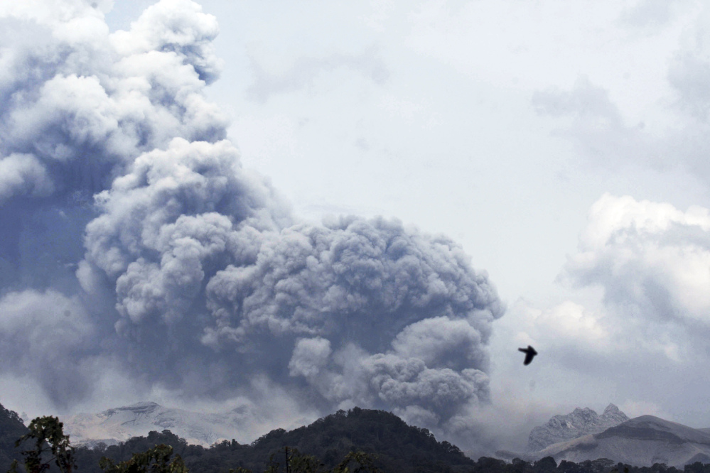 Mount Kelud erupts, as seen from Anyar village in Blitar, East Java, Indonesia on Friday. Volcanic ash shrouded a large swath of the country’s most densely populated island, closing three international airports.