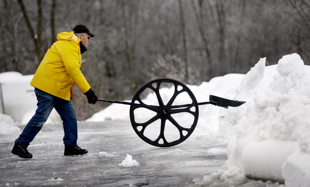 George Doody, 80, of Saco uses a Sno Wovel to clear snow from his driveway Friday. More snow is coming Saturday.