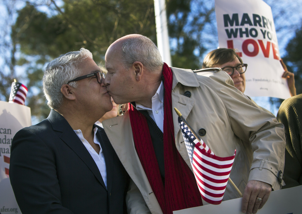 From left, Robert Roman and Claus Ihlemann of Virginia Beach celebrate Thursday’s ruling by federal Judge Arenda Wright Allen that Virginia’s same-sex marriage ban was unconstitutional during a news conference Friday in Norfolk, Va.