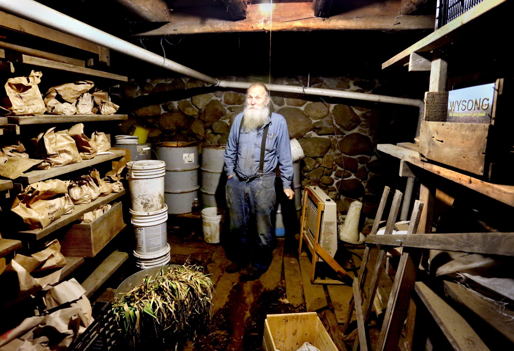 Will Bonsall stands in the root cellar of his farm in Industry where he stores hundreds of varieties of potatoes in paper bags. Highly regarded by the growing international community of seed savers, the curator still believes in growing and harvesting the seed he preserves, saying a potato needs to live in the ground in order to keep living and evolving.