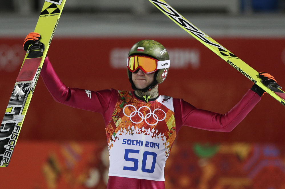 Poland’s Kamil Stoch celebrates winning the gold during the ski jumping large hill final at the 2014 Winter Olympics on Saturday in Krasnaya Polyana, Russia.