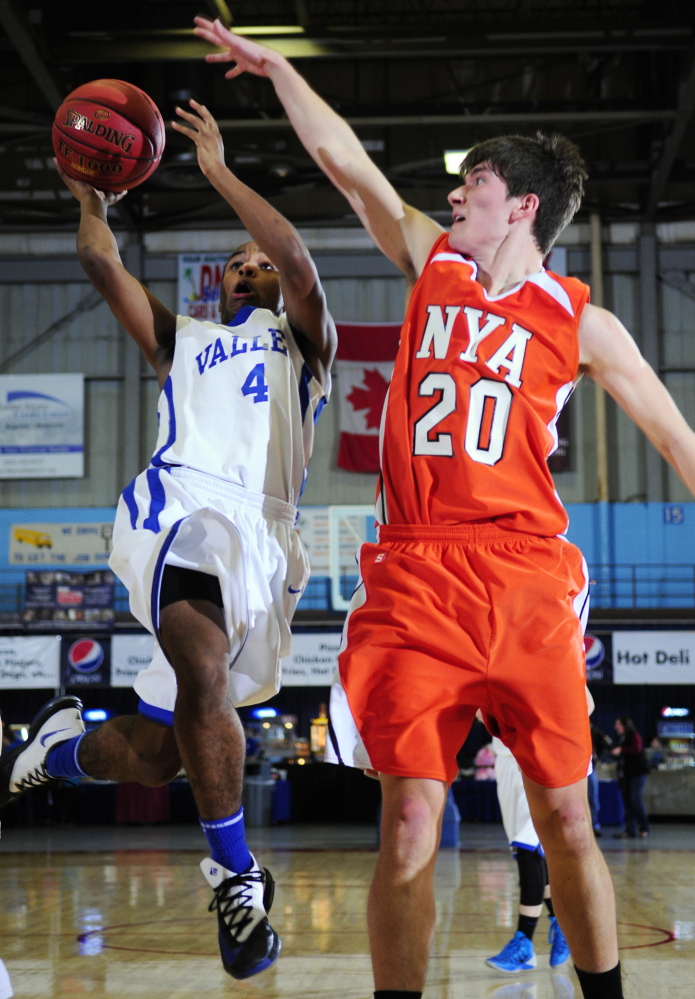 LAYUP: Valley guard Jordan Gillespie, left, goes for a shot past NYA forward Forrest Chicoine during a Western Maine Class D quaterfinal game Saturday at the Augusta Civic Center. The Cavaliers won 70-47.