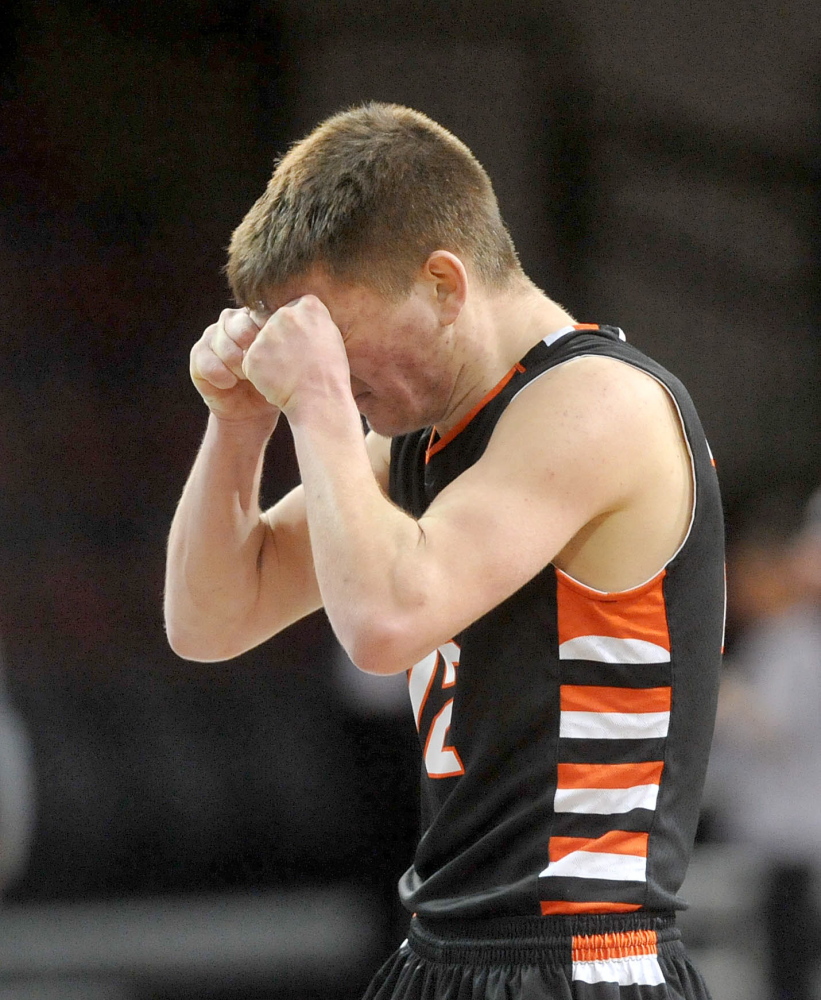 Agony of defeat: Winslow’s Connor WIldes, 12, reacts to a turnover late in the fourth quarter Saturday against Caribou High School at Cross Insurance Center in Bangor. Caribou defeated Winslow 63-61.