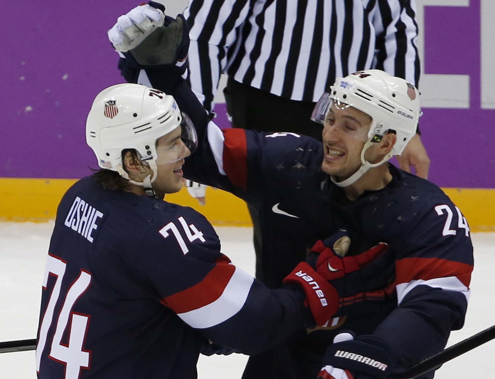 USA forward T.J. Oshie is congratulated by forward Ryan Callahan after scoring the winning goal in a shootout against Russia in a men’s hockey game at the 2014 Winter Olympics on Saturdayin Sochi, Russia. The USA won 3-2.