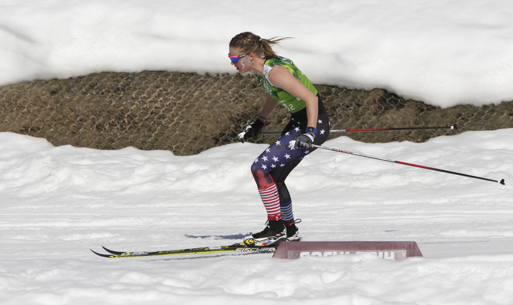United States’ Sadie Bjornsen skis in a sleeveless top past a hole in the snow during the women’s 4x5K cross-country relay.