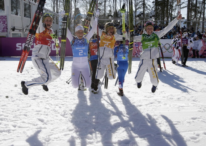 Sweden’s women’s 4x5K cross-country relay team Ida Ingemarsdotter, left, Emma Wiken, right, Anna Haag, second right, and Charlotte Kalla celebrate winning the gold during the women’s 4x5K cross-country relay at the 2014 Winter Olympics on Saturday.