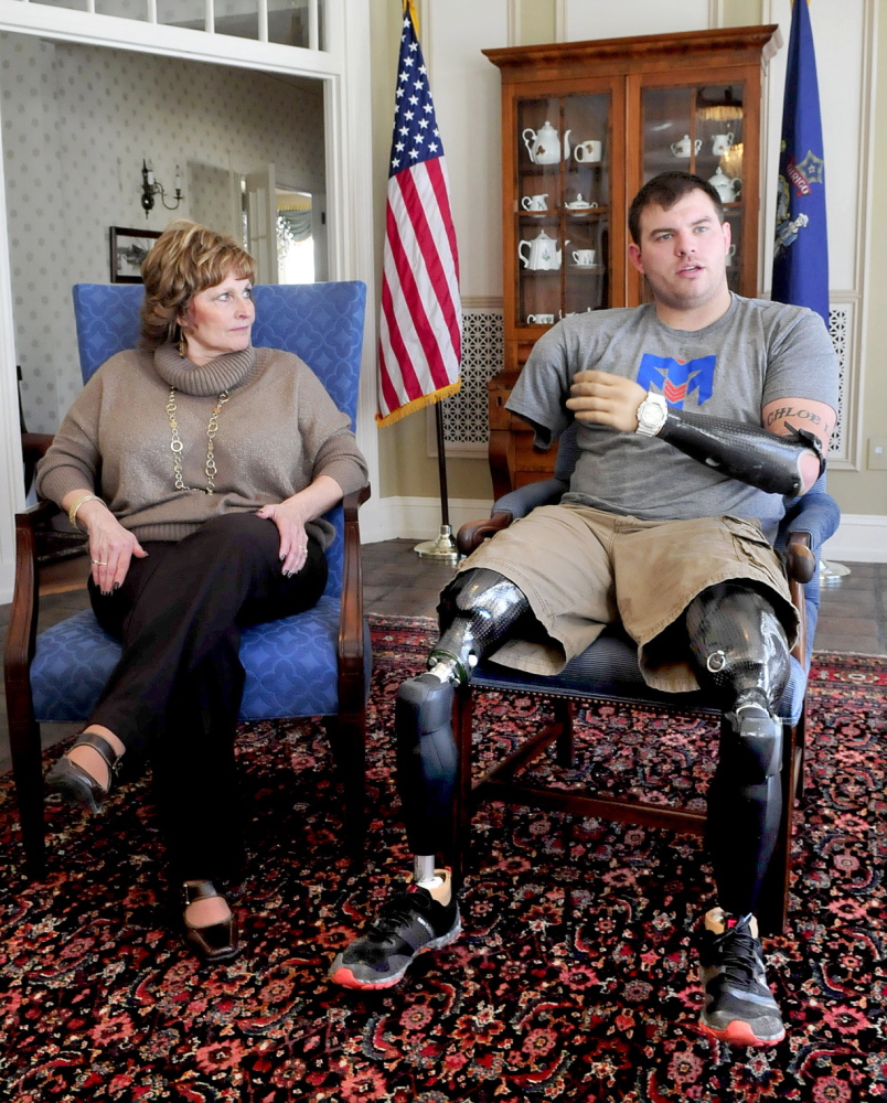 INSPIRED: First lady Ann LePage listens to Travis Mills talk on Wednesday at the Blaine House in Augusta about the effort to raise money for a recreation center on Salmon Lake in Belgrade for wounded warriors. The site’s purpose would be to help the veterans recover from their injuries.