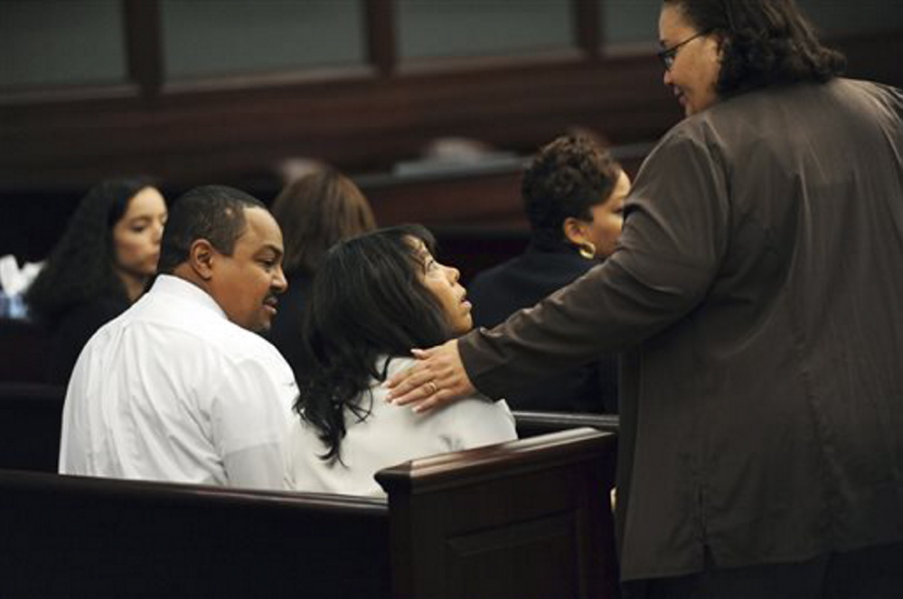 Lucia McBath, center, mother of Jordan Davis, is greeted by an unidentified woman who sat with the family in the courtroom on Saturday in Jacksonville, Fla. Her husband, Curtis McBath sits to her left. After its fourth day of deliberations, a jury found Michael Dunn guilty on three counts of attempted second-degree murder in the fatal shooting of 17-year-old Davis after an argument over loud music outside a Jacksonville convenient store in 2012.