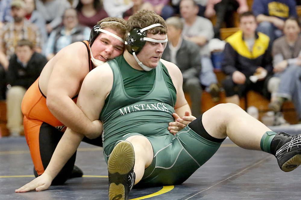 Tim Greenway/Staff Photographer Aaron Lint, left, of Winslow grapples with Chris Cole of Mt. View during their 285-pound semifinal at the Class B meet. Lint pinned Cole, then won the championship with another pin.