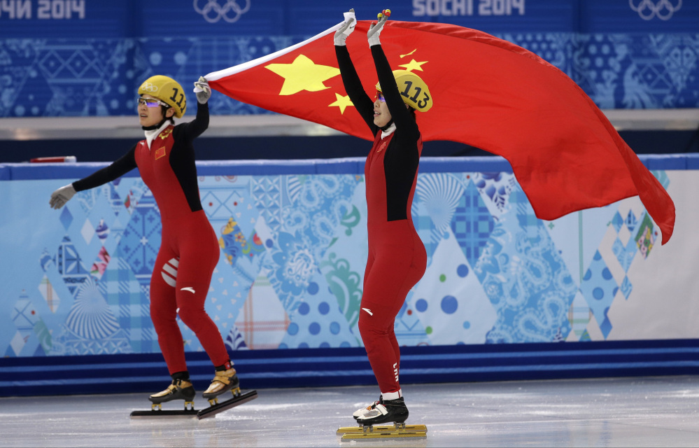 Zhou Yang of China, right, celebrates placing first in a women’s 1,500-meter short track speedskating final with Li Jianrou of China, left, at the Iceberg Skating Palace during the 2014 Winter Olympics on Saturday in Sochi, Russia.