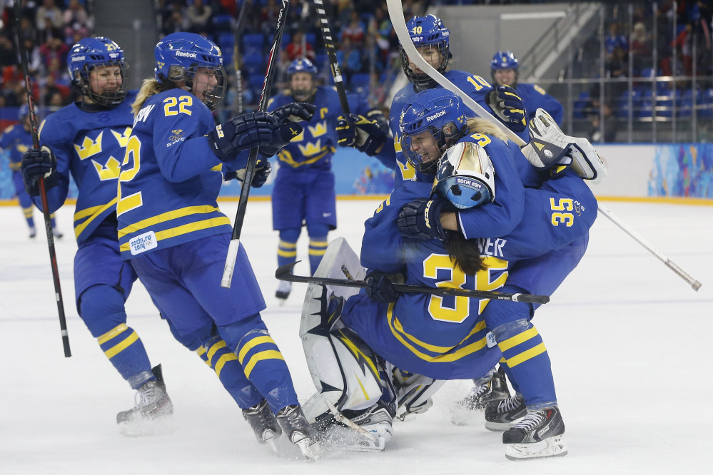 Team Sweden celebrates this a4-2 victory over Finland during the 2014 Winter Olympics women’s hockey quarterfinal game at Shayba Arena on Saturday in Sochi, Russia. Sweden will play the United States in the semifinals.