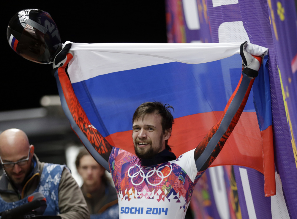 Alexander Tretiakov of Russia celebrates in the finish area after he won the gold medal during the men’s skeleton competition at the 2014 Winter Olympics, Saturday in Krasnaya Polyana, Russia.