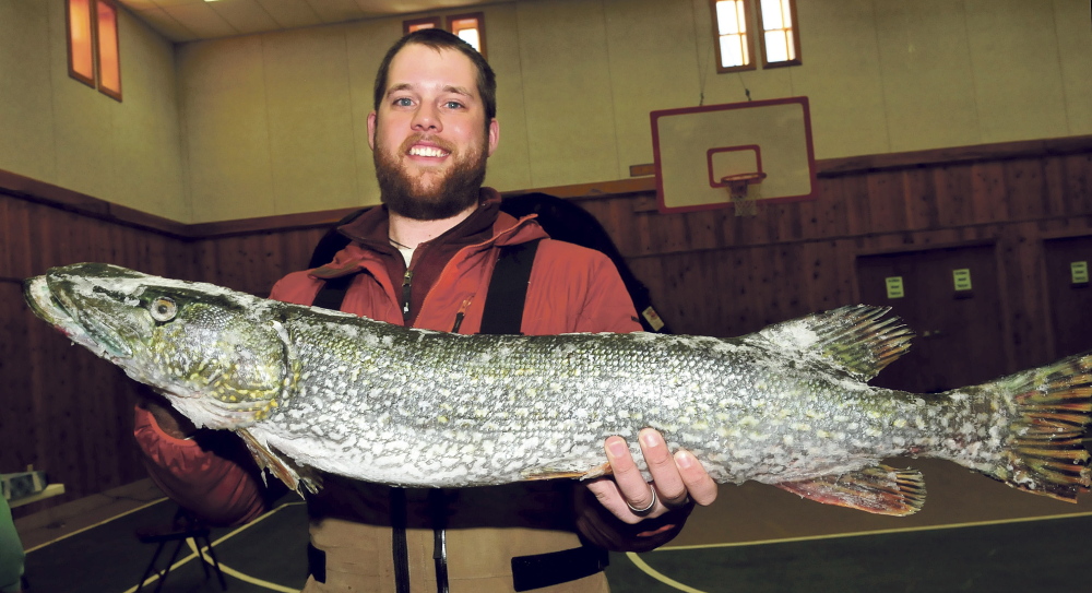 BIG OL’ FISH: Nick Workman, of Rome, holds the pike he caught and entered in the statewide Belgrade Draggin Masters Snowmobile club fishing derby on Sunday.