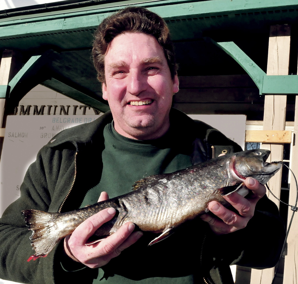 CATCH OF THE DAY: Charles Colby, of Palmyra, holds the brook trout he caught and entered in the statewide Belgrade Draggin Masters Snowmobile club fishing derby on Sunday. Colby caught the fish in Clayton Lake in Aroostook County earlier in the day.