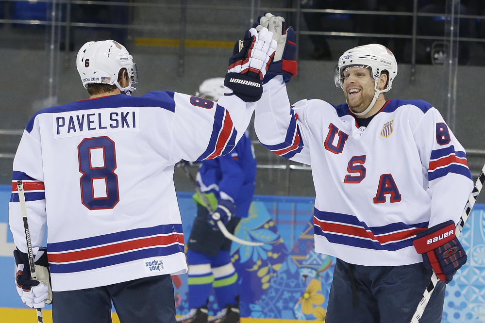 USA forward Phil Kessel, right, celebrates his second goal with teammate Joe Pavelski during the 2014 Winter Olympics men’s hockey game against Slovenia at Shayba Arena Sunday in Sochi, Russia. Kessel scored three times in a 5-1 victory.