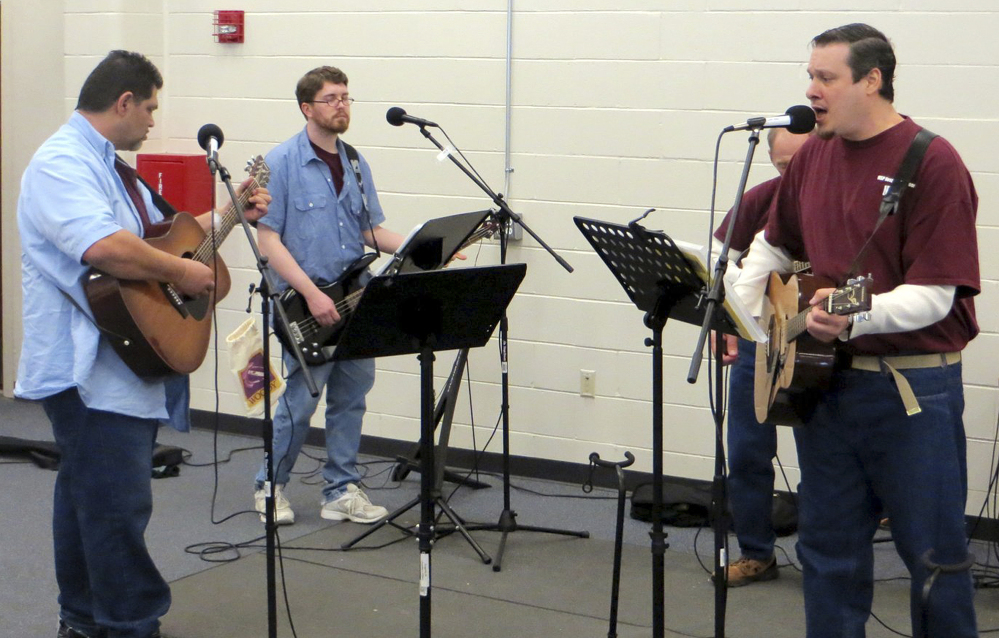From left, inmates Robert Payzant, Chris Shumway, Steve Carpentier (partially hidden) and Nathan Roy perform during a rehearsal of Sounds of Comfort, a band made up of prison hospice volunteers, at the Maine State Prison in Warren.