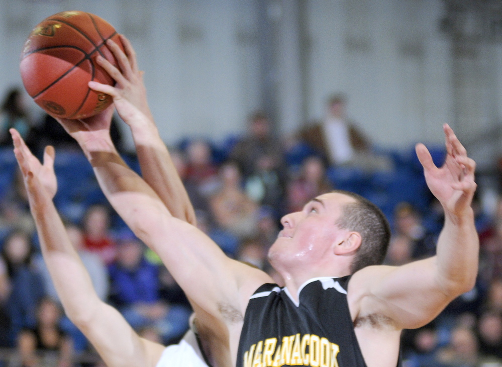 Staff photo by Andy Molloy Maranacook Community School's Cameron Brochu grabs a shot by Winthrop High School's Dakota Carter during a tournament basketball match up Monday against in Augusta.