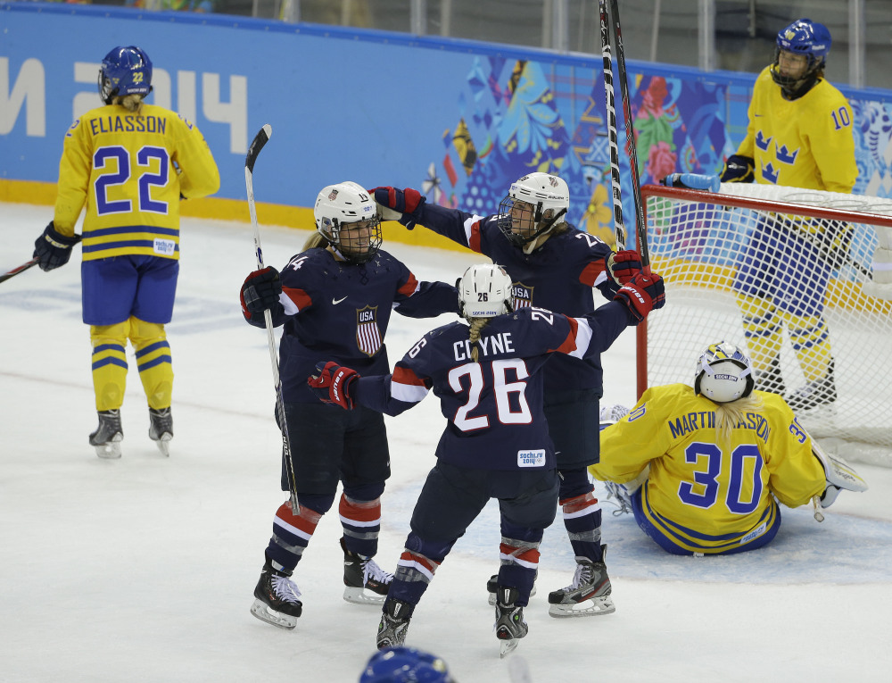 Brianna Decker of the United States (14), Kendall Coyne (26) and Amanda Kessel celebrate a goal by Decker against Sweden during the third period of the 2014 Winter Olympics women’s semifinal ice hockey game at Shayba Arena on Monday in Sochi, Russia.