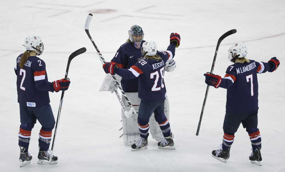 USA Goalkeeper Jessie Vetter and Amanda Kessel meet near mid ice with Lee Stecklein and Monique Lamoureux after defeating Sweden 6-1 during a 2014 Winter Olympics women’s semifinal ice hockey game at Shayba Arena on Monday in Sochi, Russia.