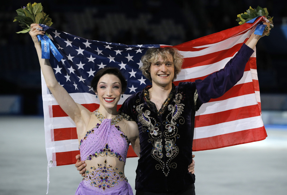 GOLD MEDAL: Meryl Davis and Charlie White of the United States pose for photographers after placing first in the ice dance free dance figure skating finals Monday at the Iceberg Skating Palace during the Winter Olympics in Sochi, Russia.