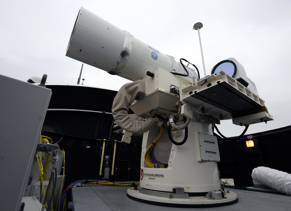 A laser weapon sits temporarily installed aboard the guided-missile destroyer USS Dewey in San Diego.