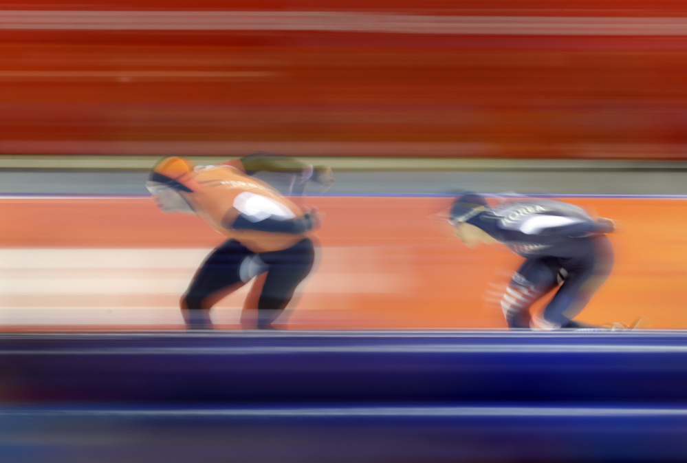Sven Kramer of the Netherlands, left, and South Korea’s Lee Seung-hoon compete in the men’s 10,000-meter speedskating race at the Adler Arena Skating Center during the 2014 Winter Olympics in Sochi, Russia, Tuesday, Feb. 18, 2014.