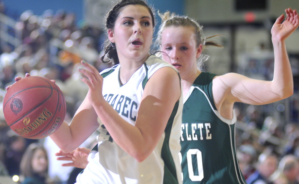 Staff photo by Andy Molloy Carrabec High School's Mickayla Willette, left, dribbles around Waynflete School's Arianna Giguere during a basketball match up Tuesday in Augusta.