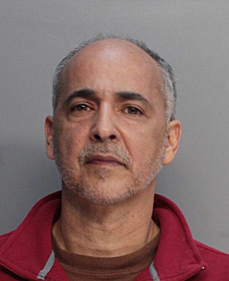 A police booking mug made available by the Miami Dade Corrections and Rehabilitation Deptartment shows artist Maximo Caminero, who is charged with criminal mischief.