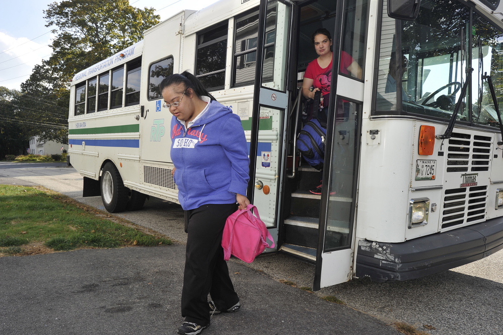 A bus arranged by Coordinated Transportation Solutions drops off Sheena Patel, who has Down syndrome, at her South Portland home last fall after her day at a sheltered work environment. After a flurry of amendments proposed by Democrats, the Legislature’s Health and Human Services Committee voted to endorse a bill that would make changes to MaineCare’s troubled rides system.