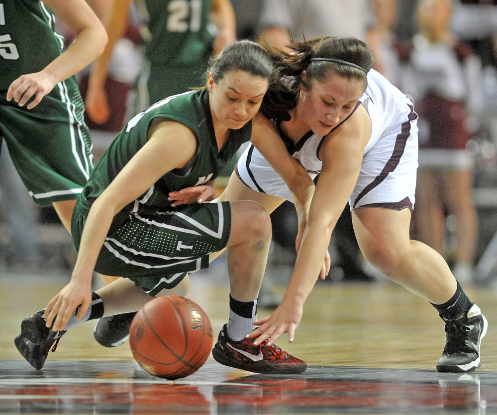 SCRAMBLE: Nokomis’ Mikalya Charters, right, and Mount Desert Island’s Sierra Tapley battle for the loose ball in the second half Wednesday at the Cross Center in Bangor. MDI defeated Nokomis 46-44.
